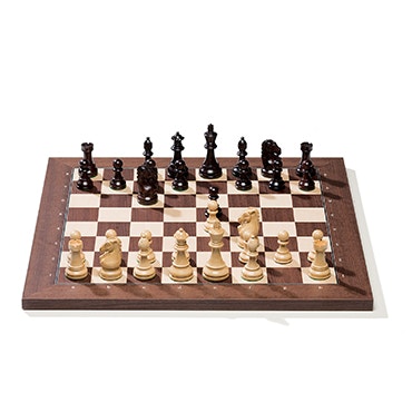 chess board with pieces in wood light and dark brown